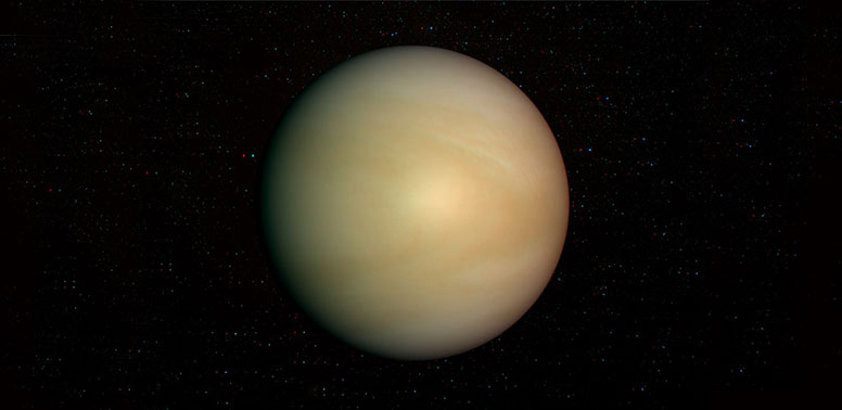 Fotografija prikazuje planet Veneru. Pozadina je crna. Vide se nejasne i mutne, svjetlucave točke koje predstavljaju zvijezde. Venera je mliječno-zelenkasto-narančaste boje.