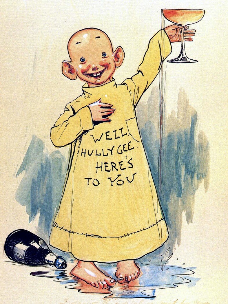 Stripovski junak – dječak bez kose u velikoj žutoj spavaćici s natpisom na engleskom jeziku, a u visoko uzdignutoj lijevoj ruci drži čašu šampanjca kojom nazdravlja. 