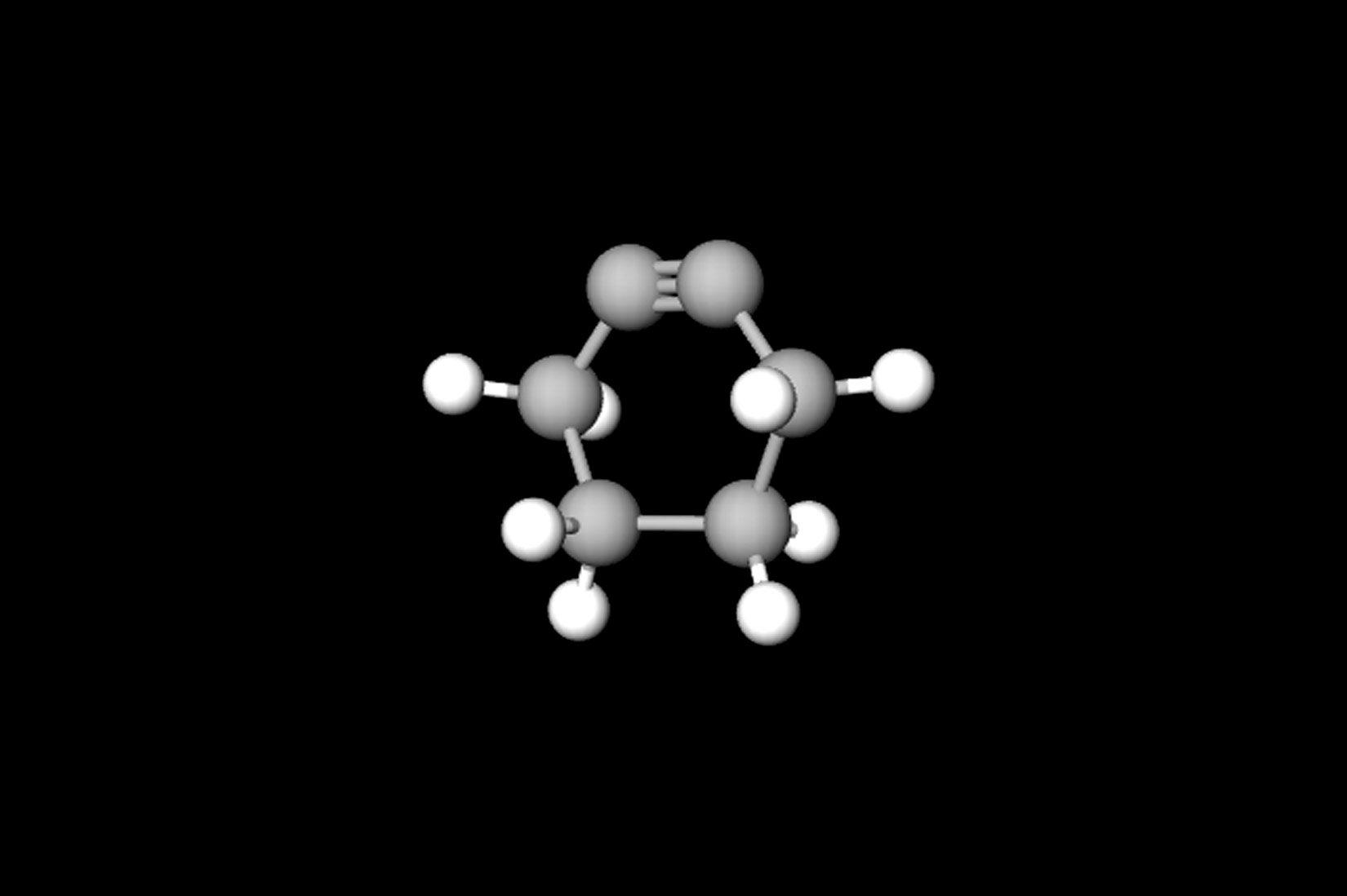 Fotografija prikazuje model molekule cikloheksina načinjen od kuglica i štapića. To je prstenasti ugljikovodik s trostrukom vezom. Šest atoma ugljika raspoređeno je u obliku prstena. Dva atoma su međusobno povezana trostrukom vezom, a sve ostale veze u prstenu su jednostruke. Neki atomi ugljika jednostrukom su vezom povezani s atomima vodika.