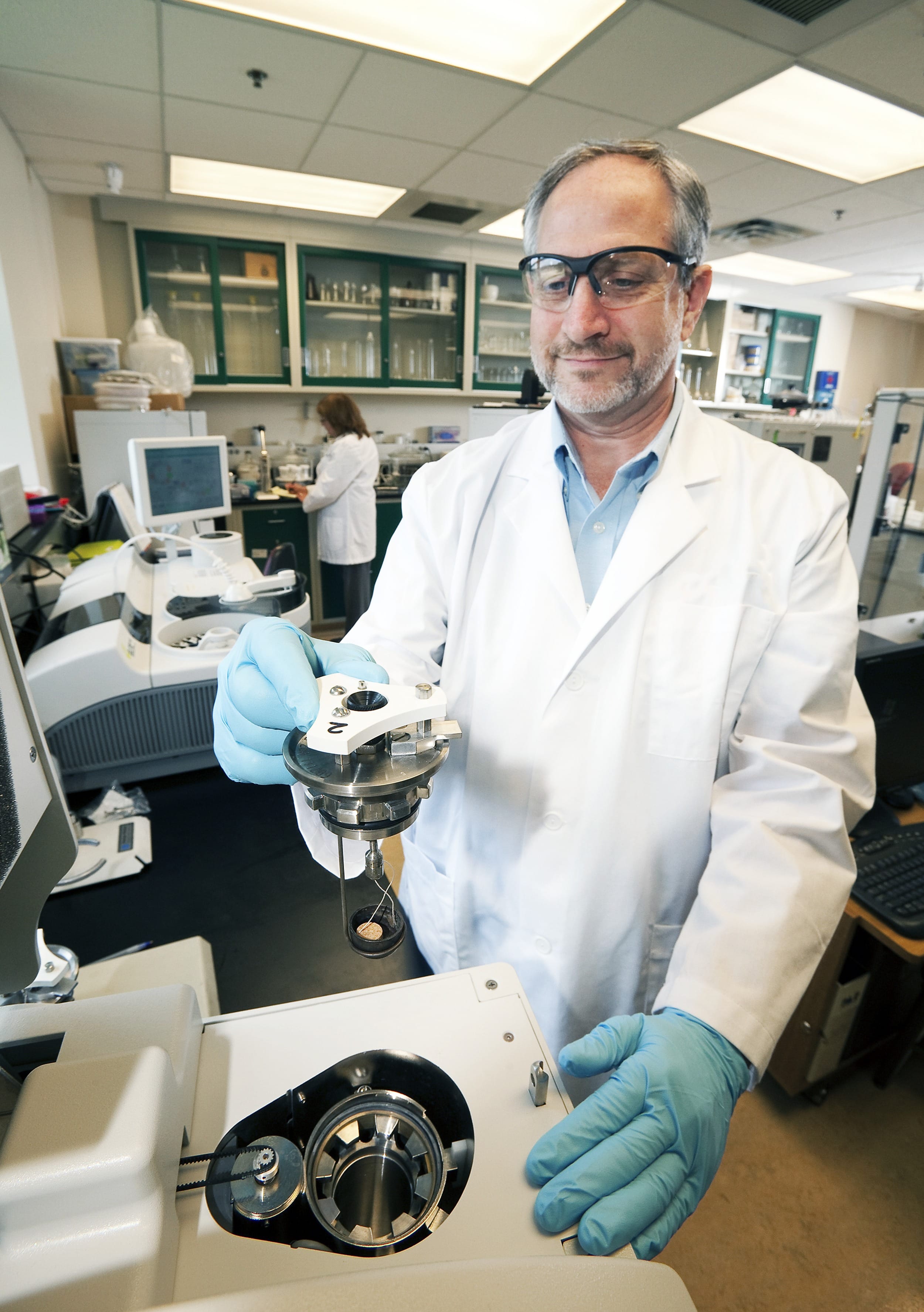 Na slici je prikazan kemijski laboratorij i kemičar koji u rukama drži kalorimetar . To je uređaj koji mjeri kalorijsku vrijednost hrane.Sastoji se od reakcijske komore, okružene vodom u izoliranom spremniku. Tijekom gorenja uzoraka hrane određene mase u reakcijskoj komori okolna se voda zagrije. Na temelju oslobođene topline može se izračunati kalorijska vrijednost hrane.