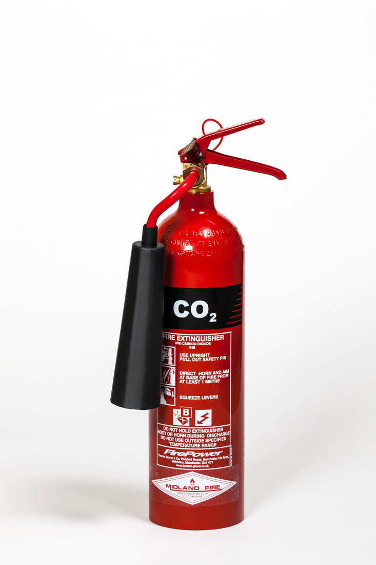 Na slici je prikazan aparat za gašenje požara.Izgleda kao izdužena metalna boca, crvene boje. Na boci su napisane upute za korištenje aparata i znak CO (ugljični monoksid).Na vrhu boce nalazi se ventil i cijev crvene boje. koja završava nastavkom za gašenje požara, crne boje.