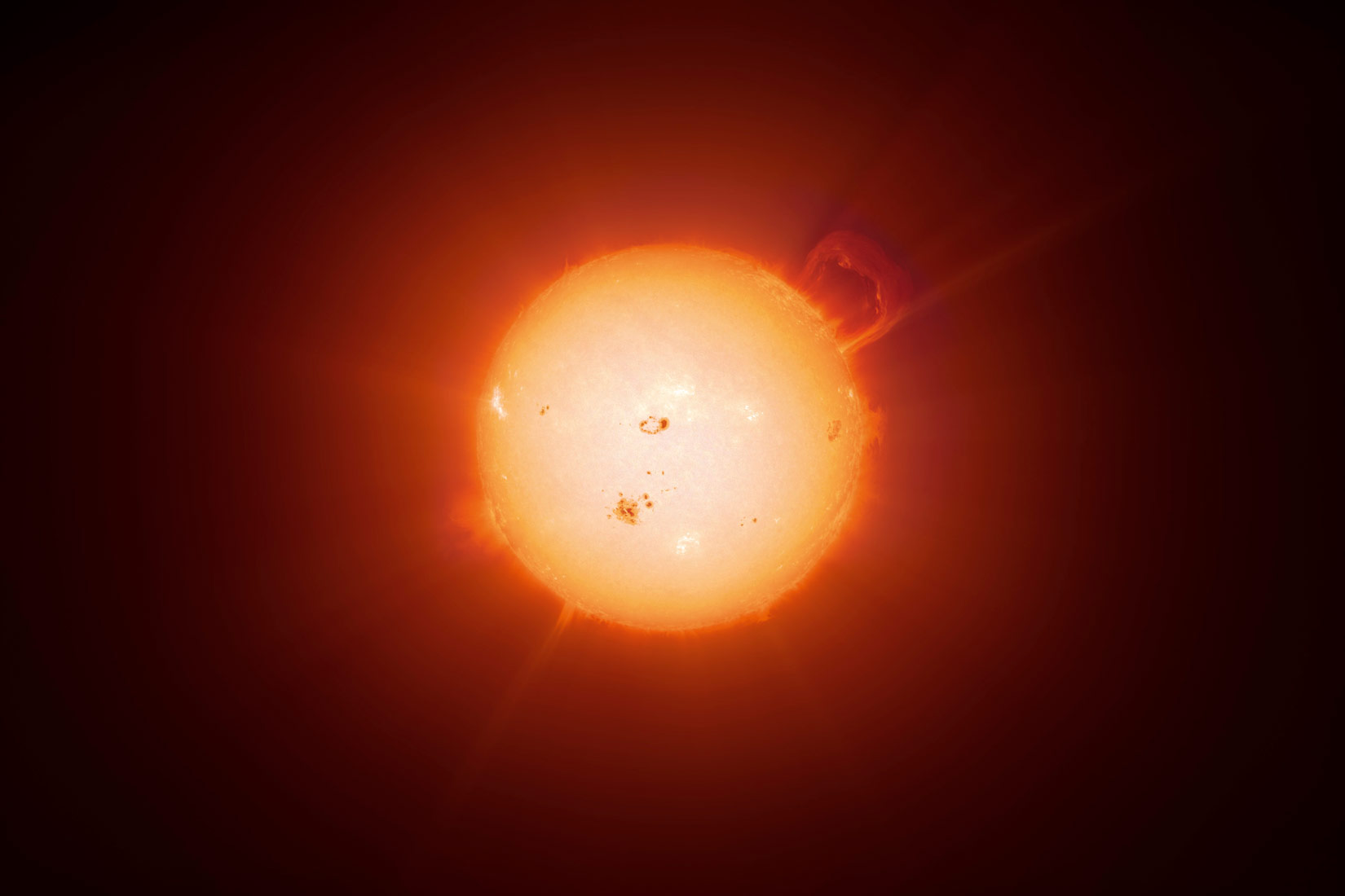 Na slici je prikazano Sunce ( žute boje u obliku kugle) iz veće blizine. Vide se Sunčeve pjege.Sunce i ostale zvijezde sastavljene su uglavnom od vodika.