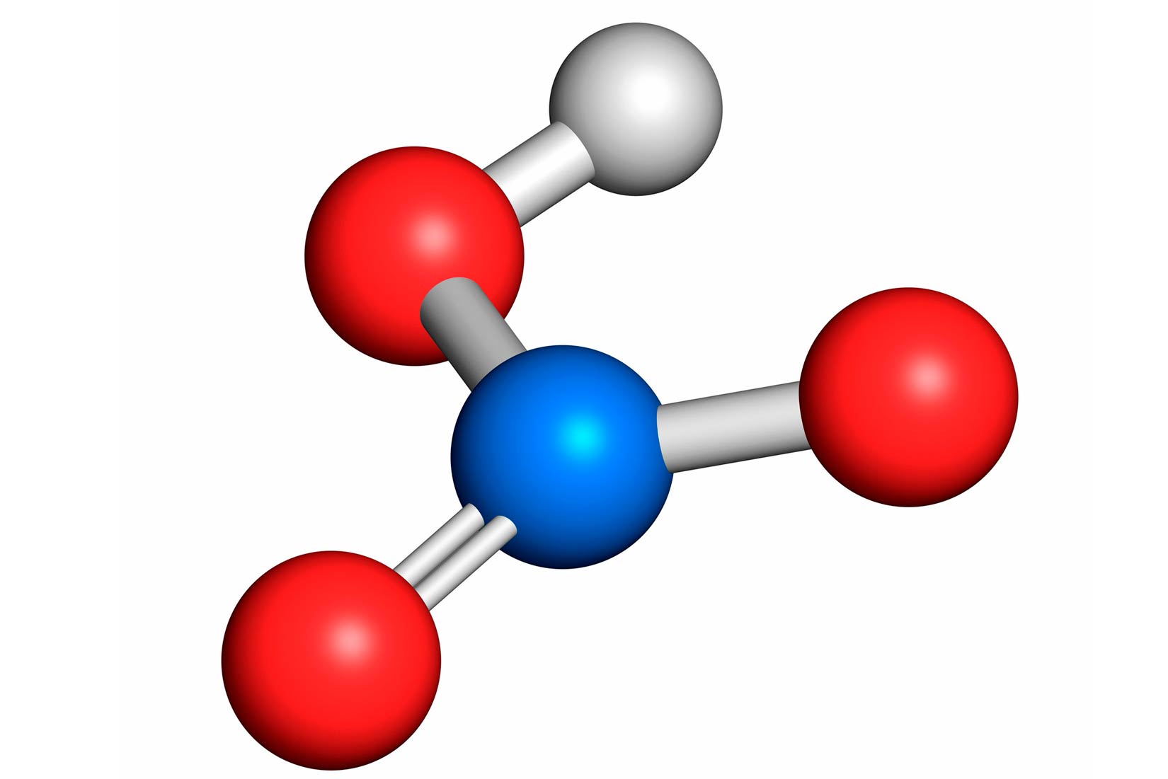 Fotografija prikazuje model molekule dušične kiseline sačinjene od kuglica i štapića, u sredini je jedna plava, oko nje su štapićima povezane tri crvene i jedna bijela kuglica.