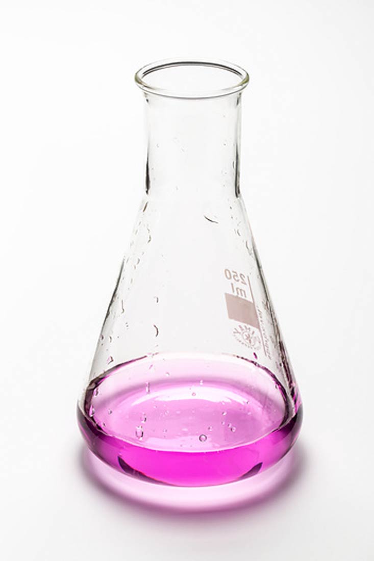 Fotografija prikazuje Erlenmeyerovu tikvicu u kojoj se nalazi tekućina ljubičaste boje.