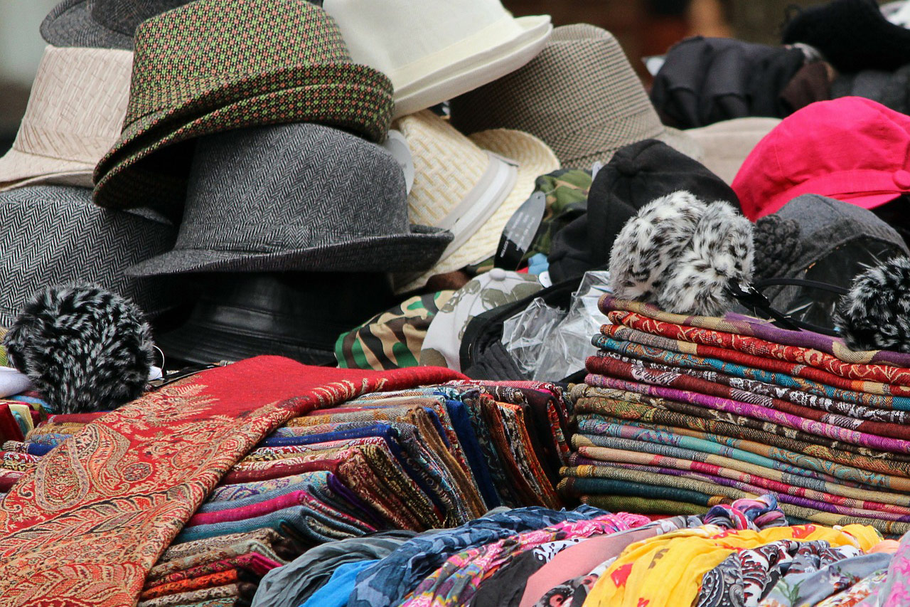 Fotografija prikazuje raznobojne šešire i šalove načinjene od prirodnih polimera - vune, svila i pamuka.