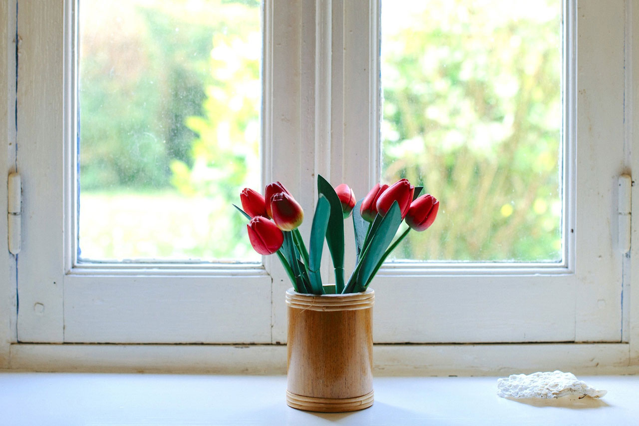 Fotografija prikazuje vazu s cvijećem.